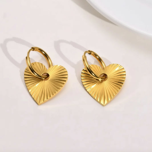 Gold heart-shaped earrings on a white background