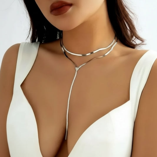 Silver choker necklace worn by a model against a neutral background