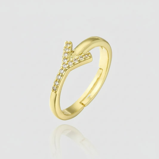 Gold ring with diamond accents on a white background