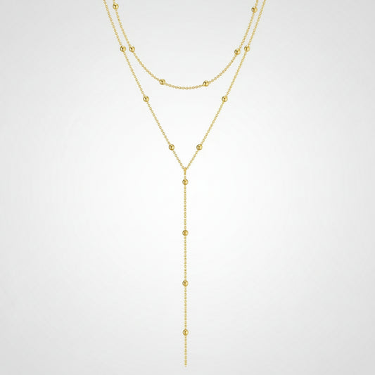 Gold necklace with beads on a white background