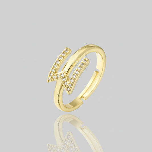 Gold ring with diamond accents on a white background
