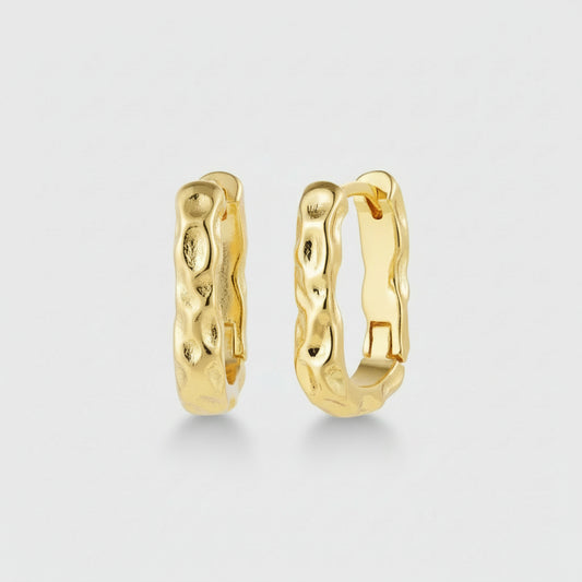 Gold hoop earrings on a white background