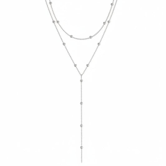 Layered silver necklace on a white background